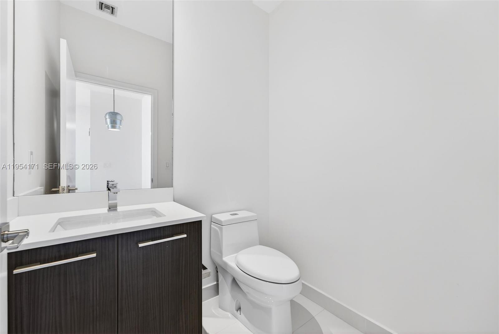 45 Southwest 9th Street, Unit LPH4609 Miami, FL 33130 - Photo 35 of 50 a bathroom with a toilet a sink and mirror