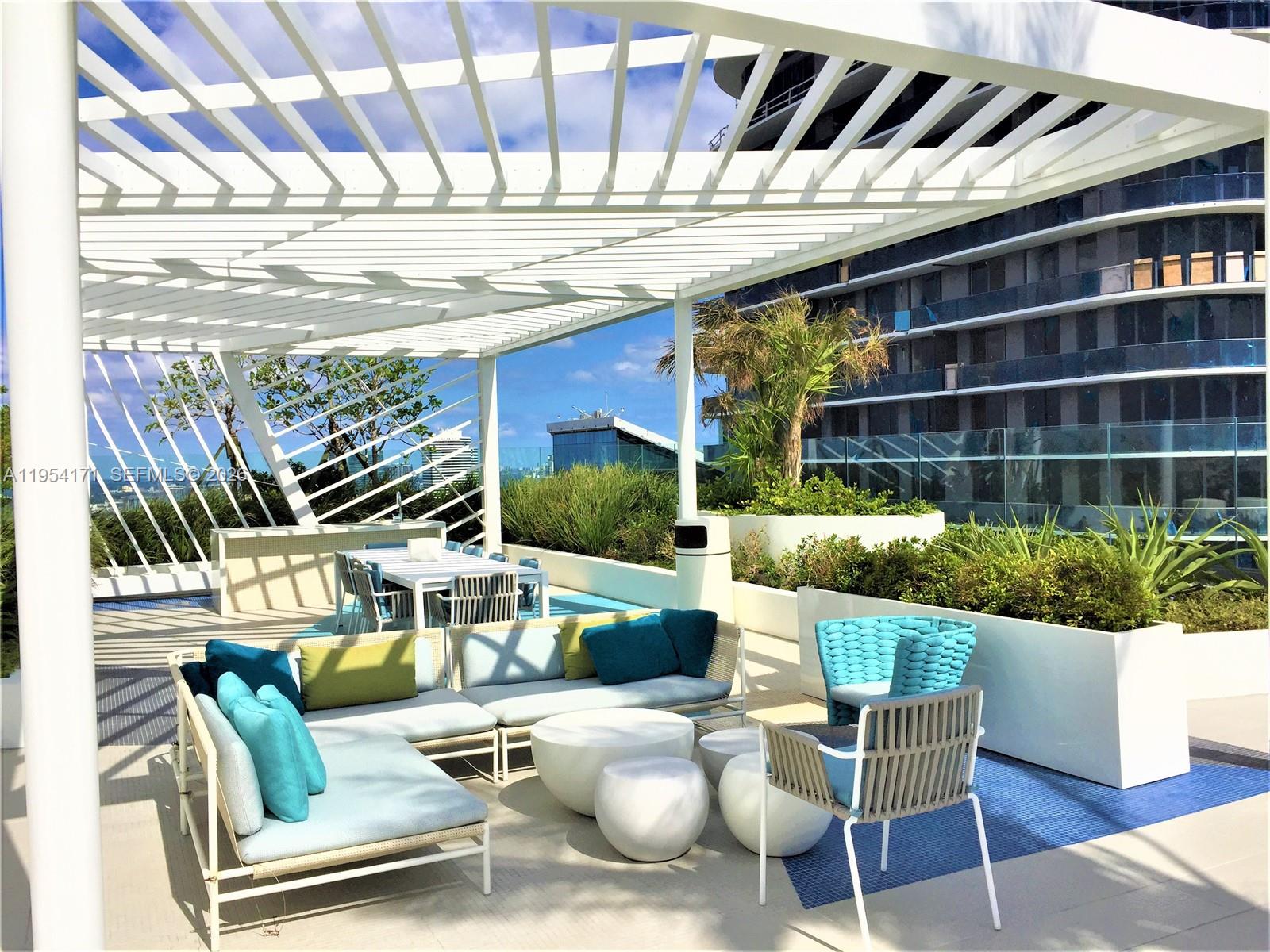 45 Southwest 9th Street, Unit LPH4609 Miami, FL 33130 - Photo 38 of 50 a building outdoor space with patio furniture and potted plants