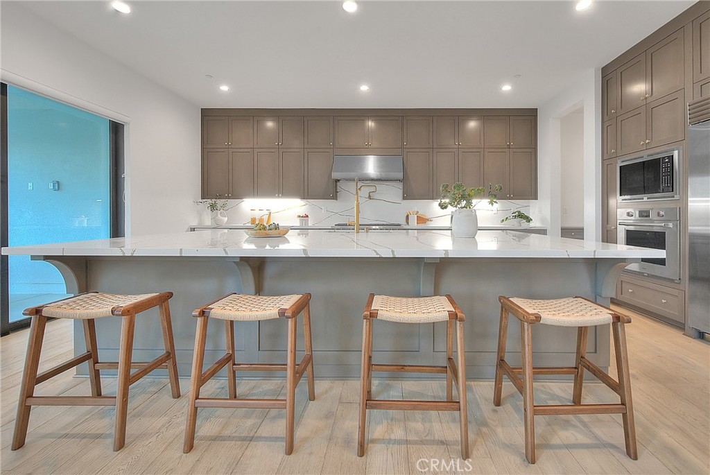 20164 Galway Lane Porter Ranch, CA 91326 - Photo 15 of 74 a kitchen with cabinets and chairs