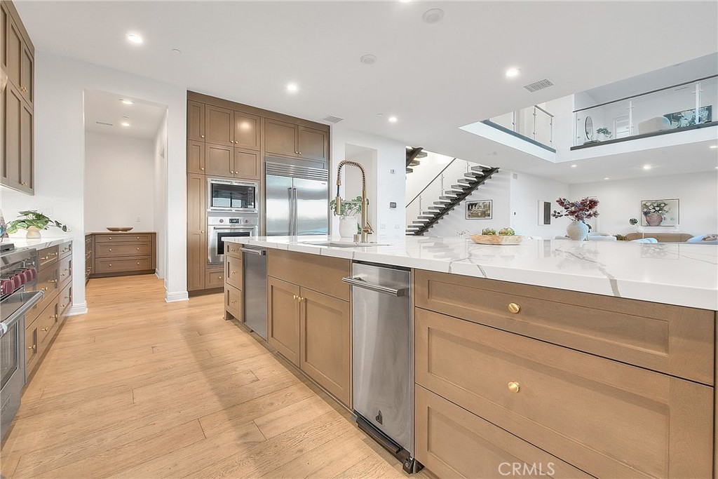 20164 Galway Lane Porter Ranch, CA 91326 - Photo 17 of 74 a large kitchen with a large counter top stainless steel appliances and cabinets