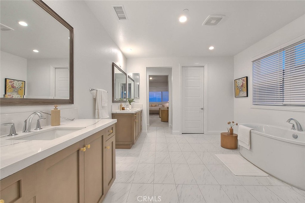 20164 Galway Lane Porter Ranch, CA 91326 - Photo 42 of 74 a spacious bathroom with a double vanity sink a mirror and a bathtub