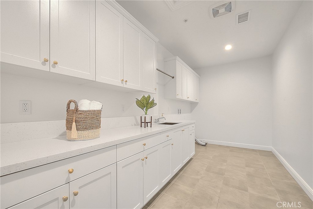 20164 Galway Lane Porter Ranch, CA 91326 - Photo 45 of 74 a kitchen with white cabinets and sink