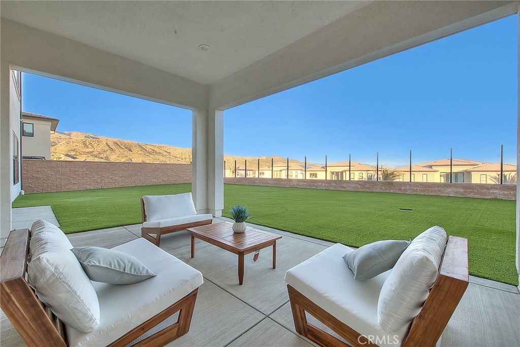 20164 Galway Lane Porter Ranch, CA 91326 - Photo 47 of 74 a view of a patio with couches and a big yard