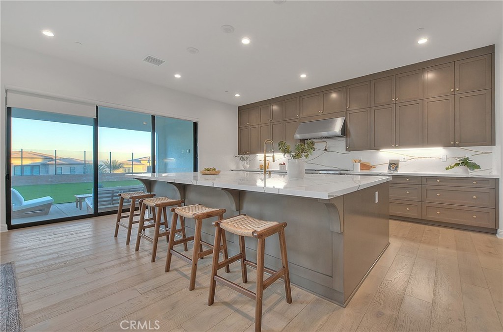 20164 Galway Lane Porter Ranch, CA 91326 - Photo 10 of 74 a kitchen with a table chairs sink and cabinets