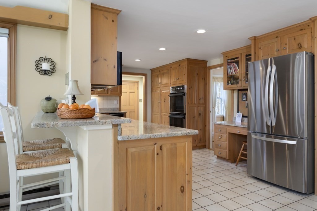 8 Townsend Road Lynnfield, MA 01940 - Photo 16 of 41 a kitchen with stainless steel appliances granite countertop a refrigerator and a stove
