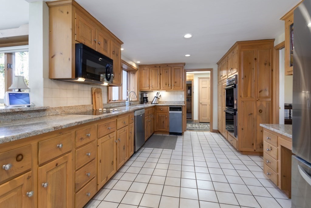 8 Townsend Road Lynnfield, MA 01940 - Photo 17 of 41 a large kitchen with stainless steel appliances granite countertop a refrigerator and a sink