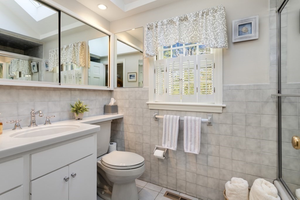 8 Townsend Road Lynnfield, MA 01940 - Photo 24 of 41 a bathroom with a sink a toilet and mirror
