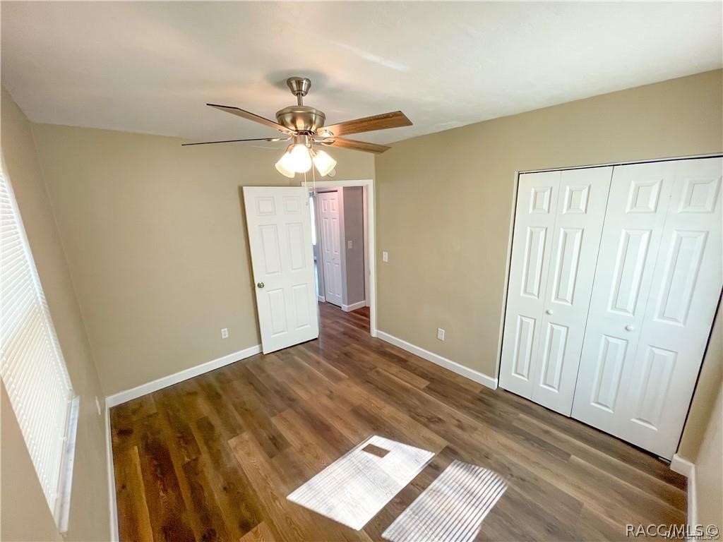 405 Copperfield Road Spring Hill, FL 34606 - Photo 14 of 25 wooden floor in an empty room with a window