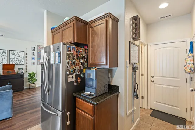 a kitchen with stainless steel appliances granite countertop a refrigerator and a stove