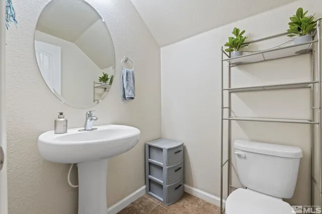 a bathroom with a sink toilet and a mirror