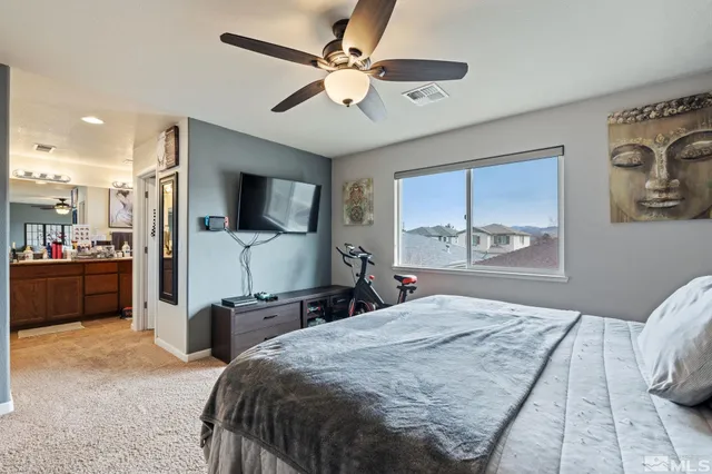 a bedroom with a balcony a bed and a flat screen tv