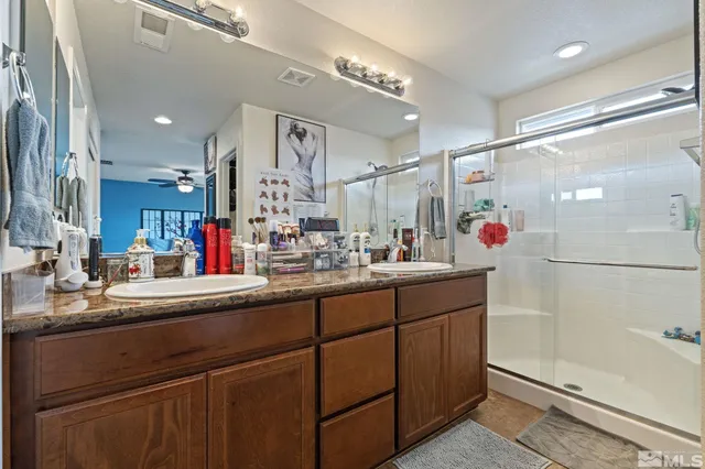 a bathroom with a sink shower and a mirror