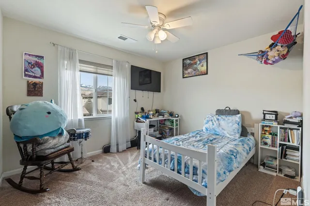 a bedroom with a bed and a chair