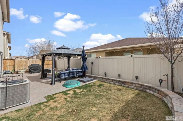 a backyard of a house with table and chairs