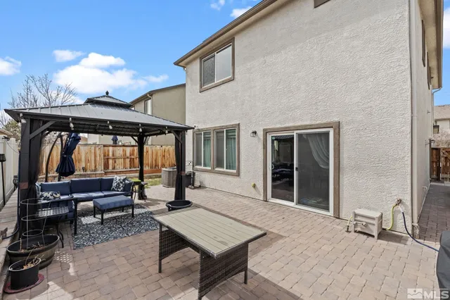 a view of a chairs and table in a patio