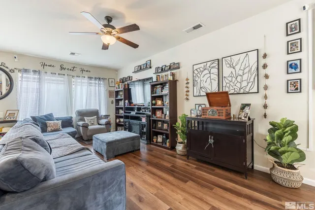 a living room with furniture kitchen view and a window