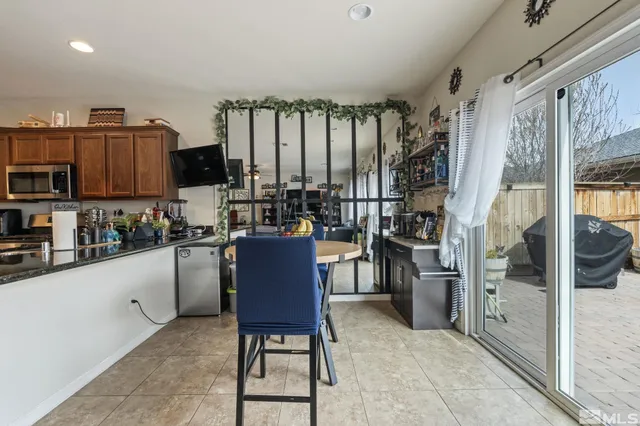 a kitchen with stainless steel appliances kitchen island granite countertop a refrigerator and a stove top oven