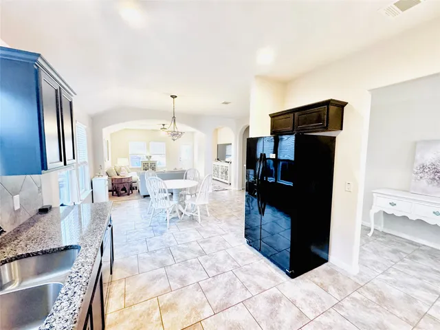 a view of a dining room with furniture and a chandelier