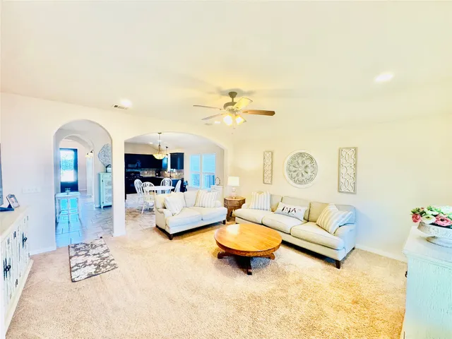 a living room with furniture and a chandelier