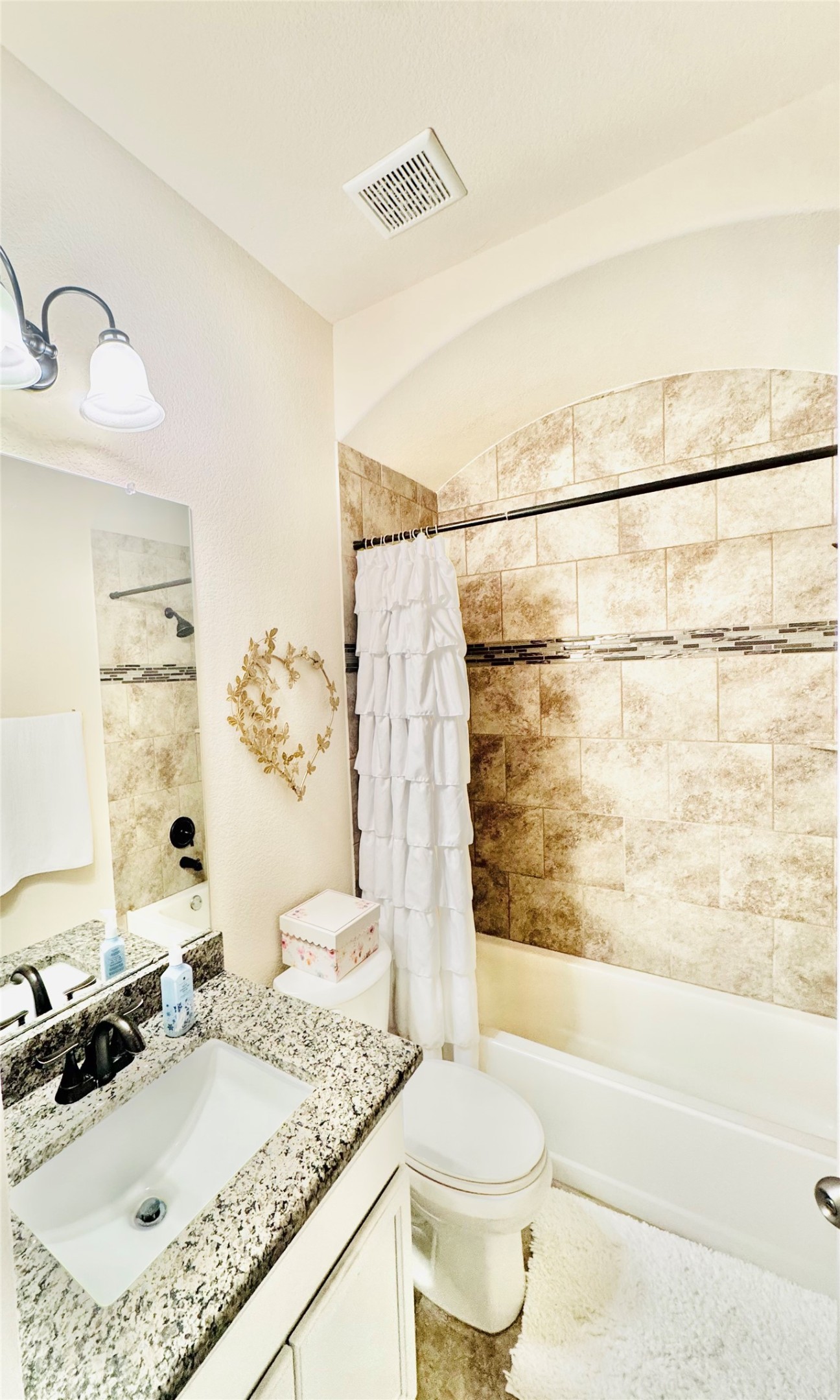 413 Gettysburg Loop Elgin, TX 78621 - Photo 23 of 32 a bathroom with a granite countertop sink and a mirror