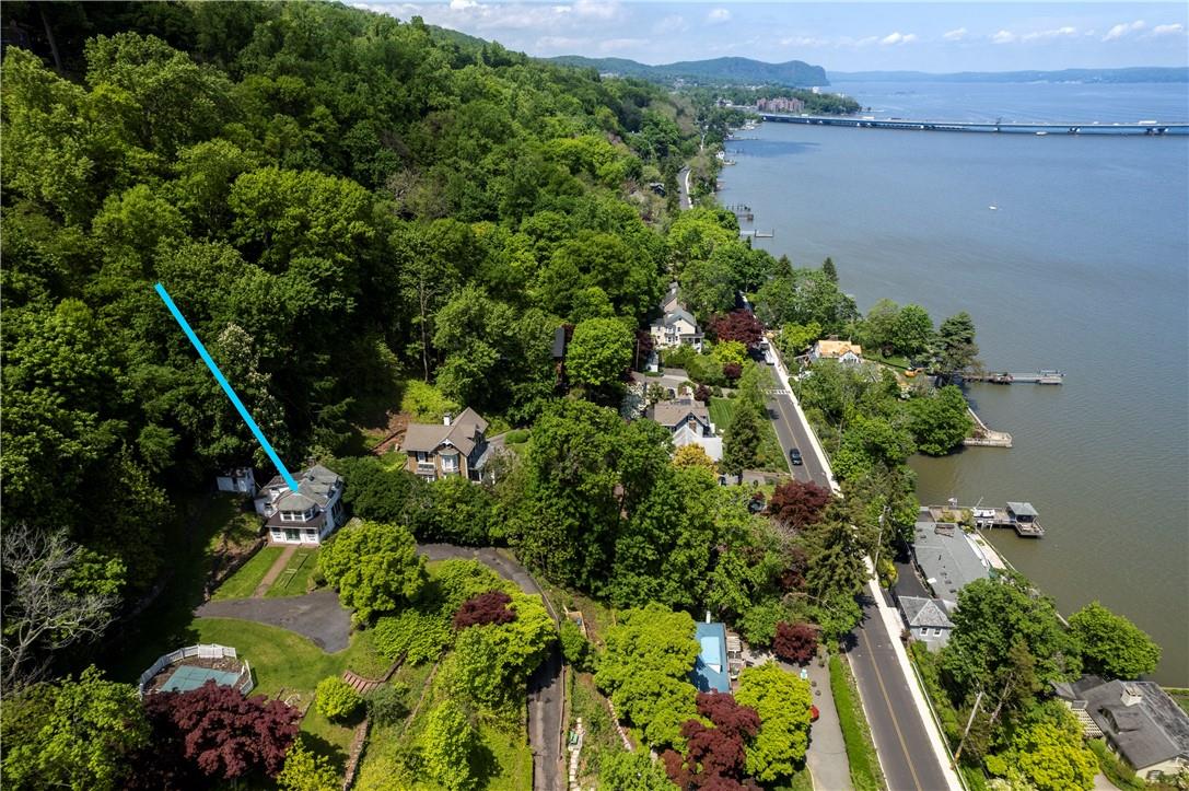 an aerial view of a residential houses with outdoor space and swimming pool