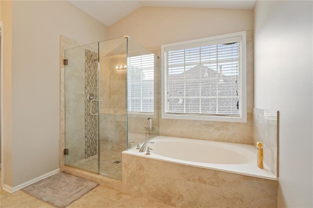 878 Scales Road Suwanee, GA 30024 - Photo 12 of 17 a bathroom with a bathtub and shower