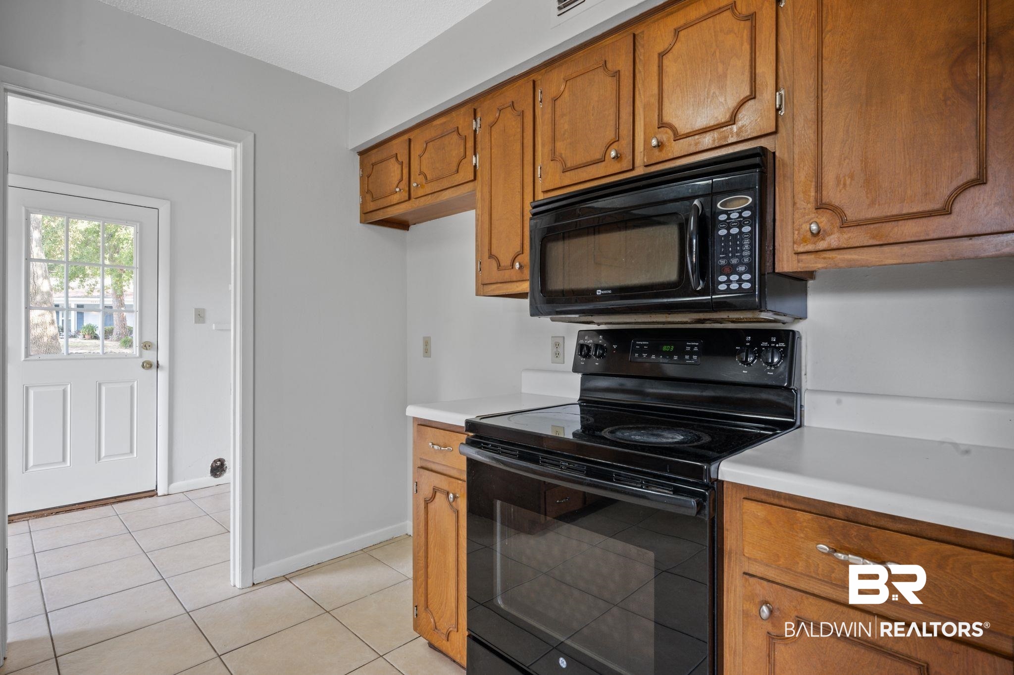 3701 Vista Ridge Drive Mobile, AL 36693 - Photo 13 of 33 Kitchen with black appliances and light tile patterned floors