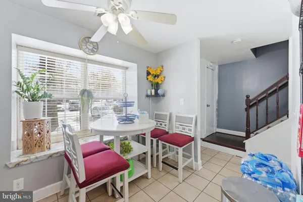 a living room with furniture a chandelier and a window
