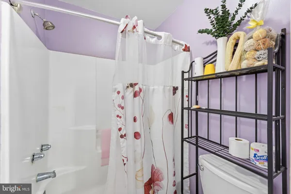 a bathroom with a bathtub and shower