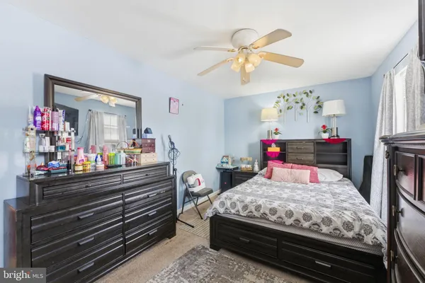a bedroom with a bed and dresser