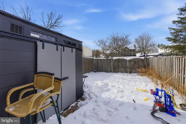 a backyard of a house with wooden fence