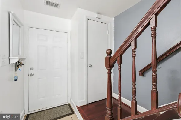 a view of entryway with wooden floor and stairs