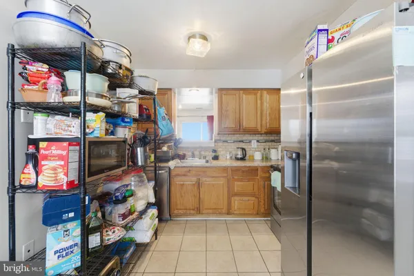 a kitchen with stainless steel appliances granite countertop a refrigerator and a stove