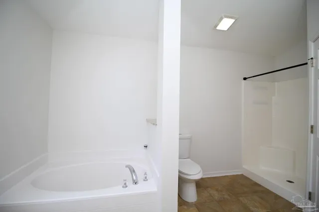 a white bath tub sitting next to a toilet