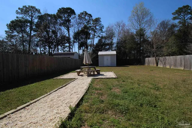 a view of a backyard with a sitting area