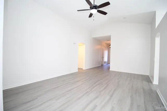 a view of a room with wooden floor and white walls