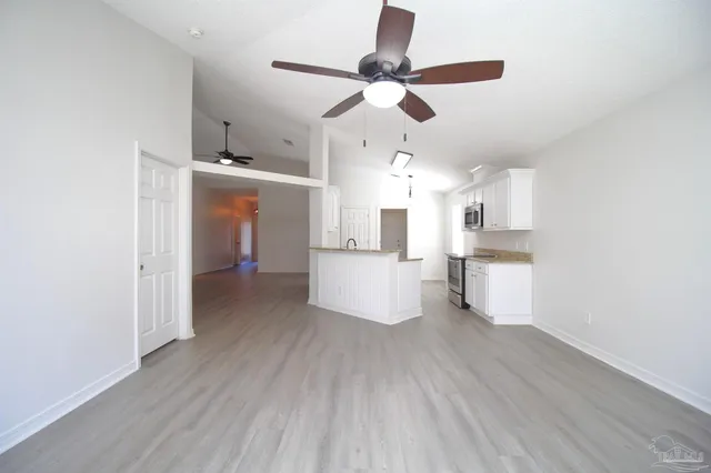 a view of a kitchen with a sink and wooden floor