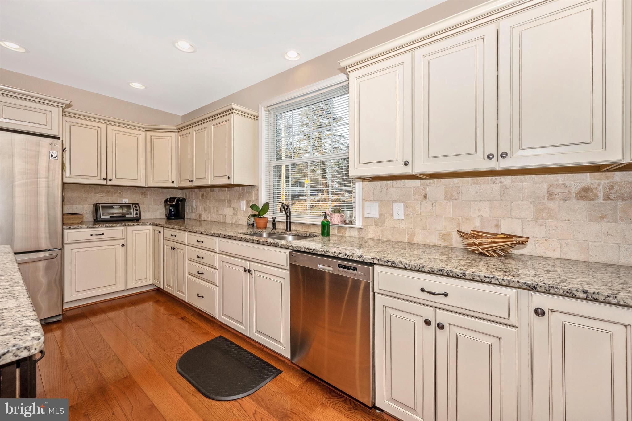 12529 Fingerboard Road Monrovia, MD 21770 - Photo 16 of 55 a kitchen with granite countertop white cabinets white appliances a sink and a window