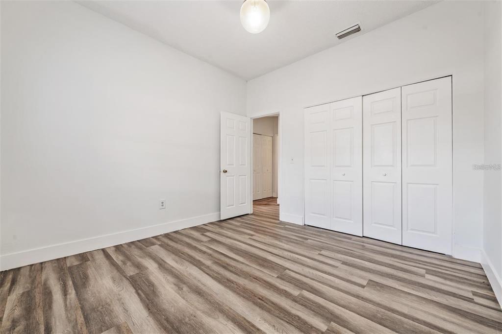 8304 North 13th Street Tampa, FL 33604 - Photo 11 of 22 a view of an empty room with wooden floor