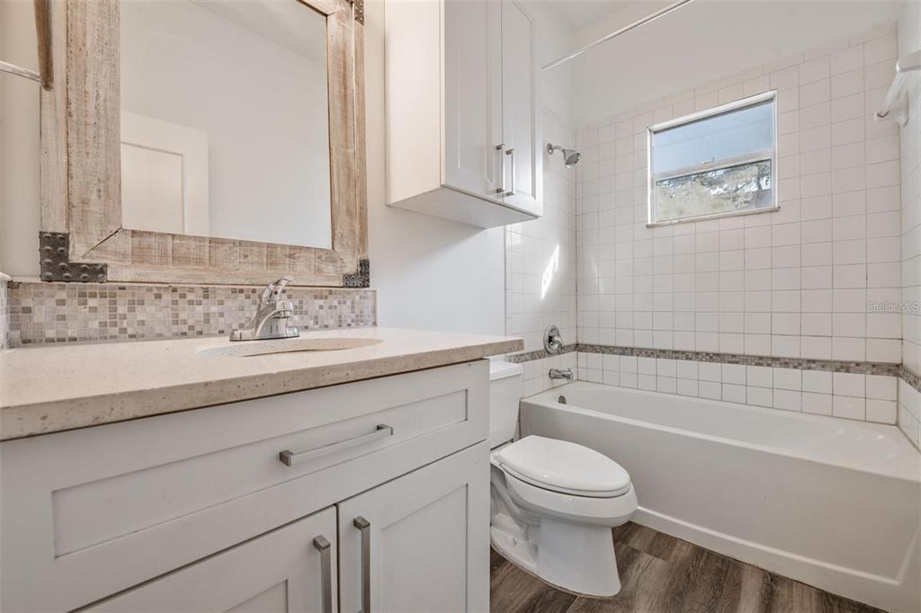 8304 North 13th Street Tampa, FL 33604 - Photo 12 of 22 a bathroom with a sink a toilet and shower