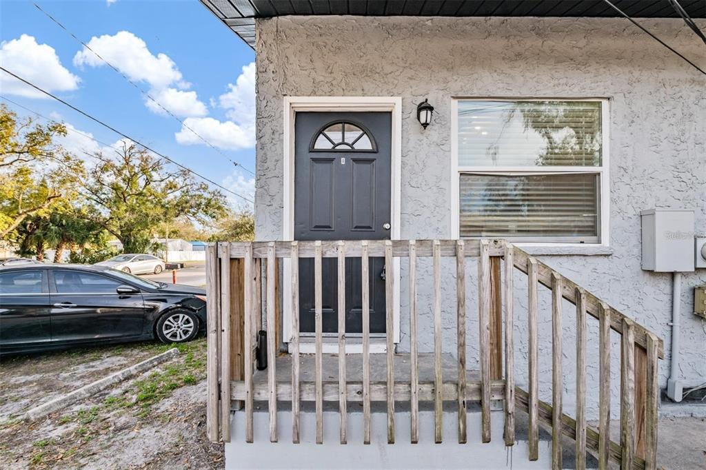 8304 North 13th Street Tampa, FL 33604 - Photo 2 of 22 a view of a brick house with a bench next to a yard