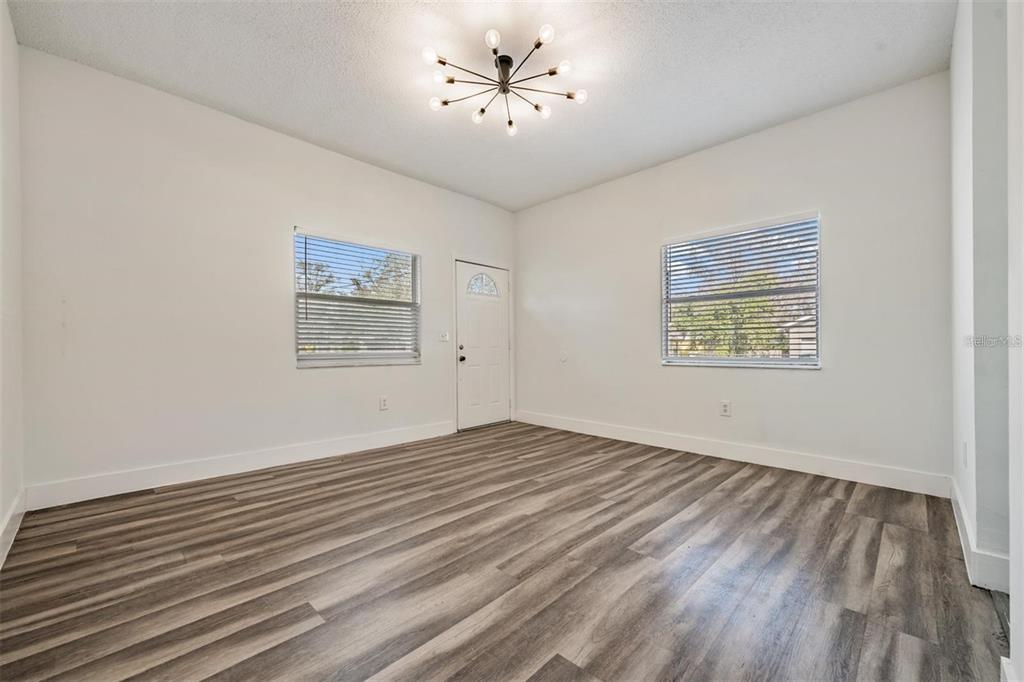 8304 North 13th Street Tampa, FL 33604 - Photo 3 of 22 a view of an empty room with a window and a ceiling fan