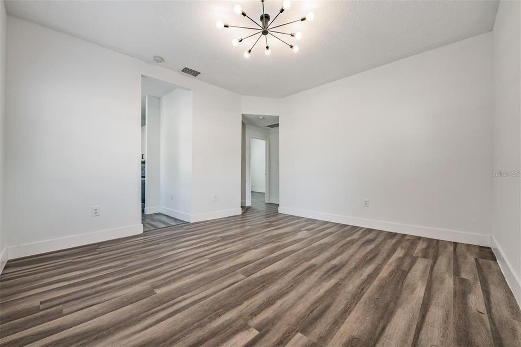 8304 North 13th Street Tampa, FL 33604 - Photo 4 of 22 a view of an empty room with wooden floor