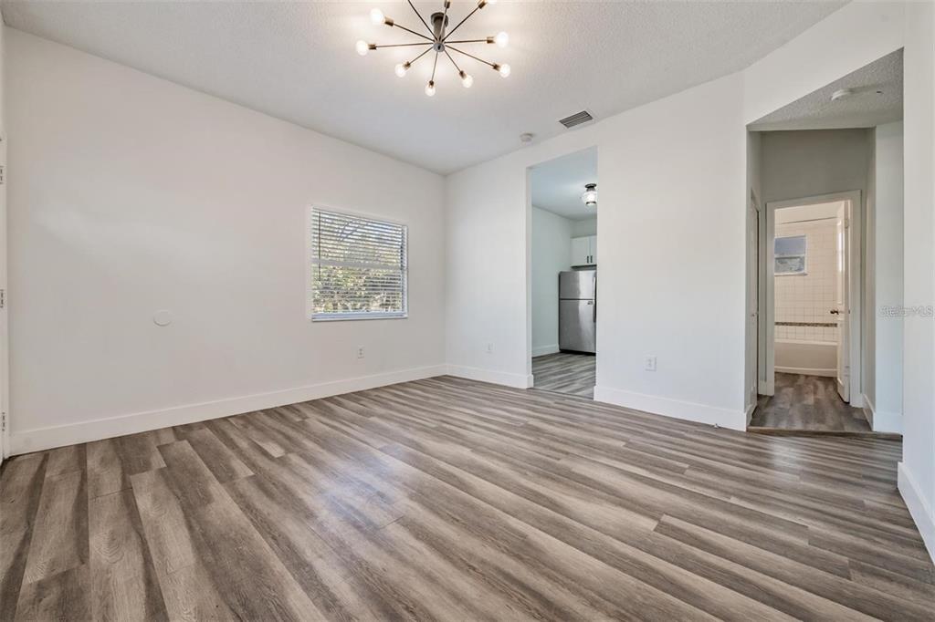8304 North 13th Street Tampa, FL 33604 - Photo 5 of 22 wooden floor in an empty room with a window