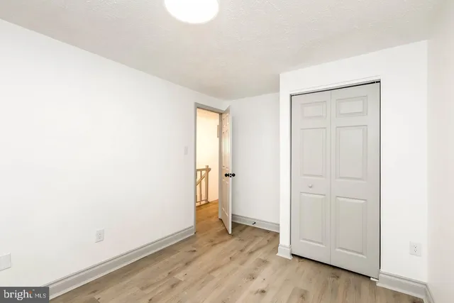 a view of an empty room and wooden floor