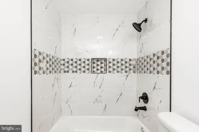 a bathroom with a sink a toilet and a bathtub