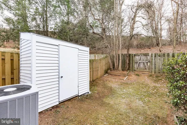 a view of a house with backyard and a garage