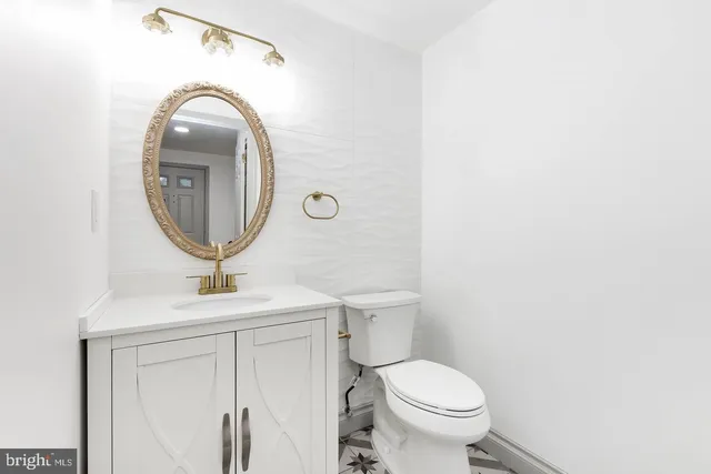 a bathroom with a toilet sink and mirror
