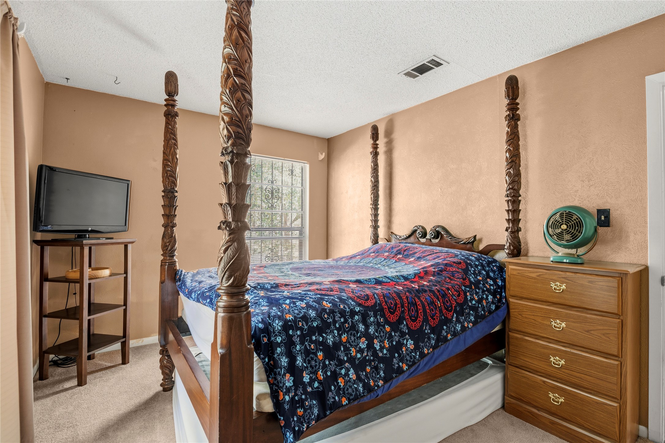 5403 Jeffburn Cove Austin, TX 78745 - Photo 33 of 40 a bedroom with a bed and a flat tv screen on the dresser