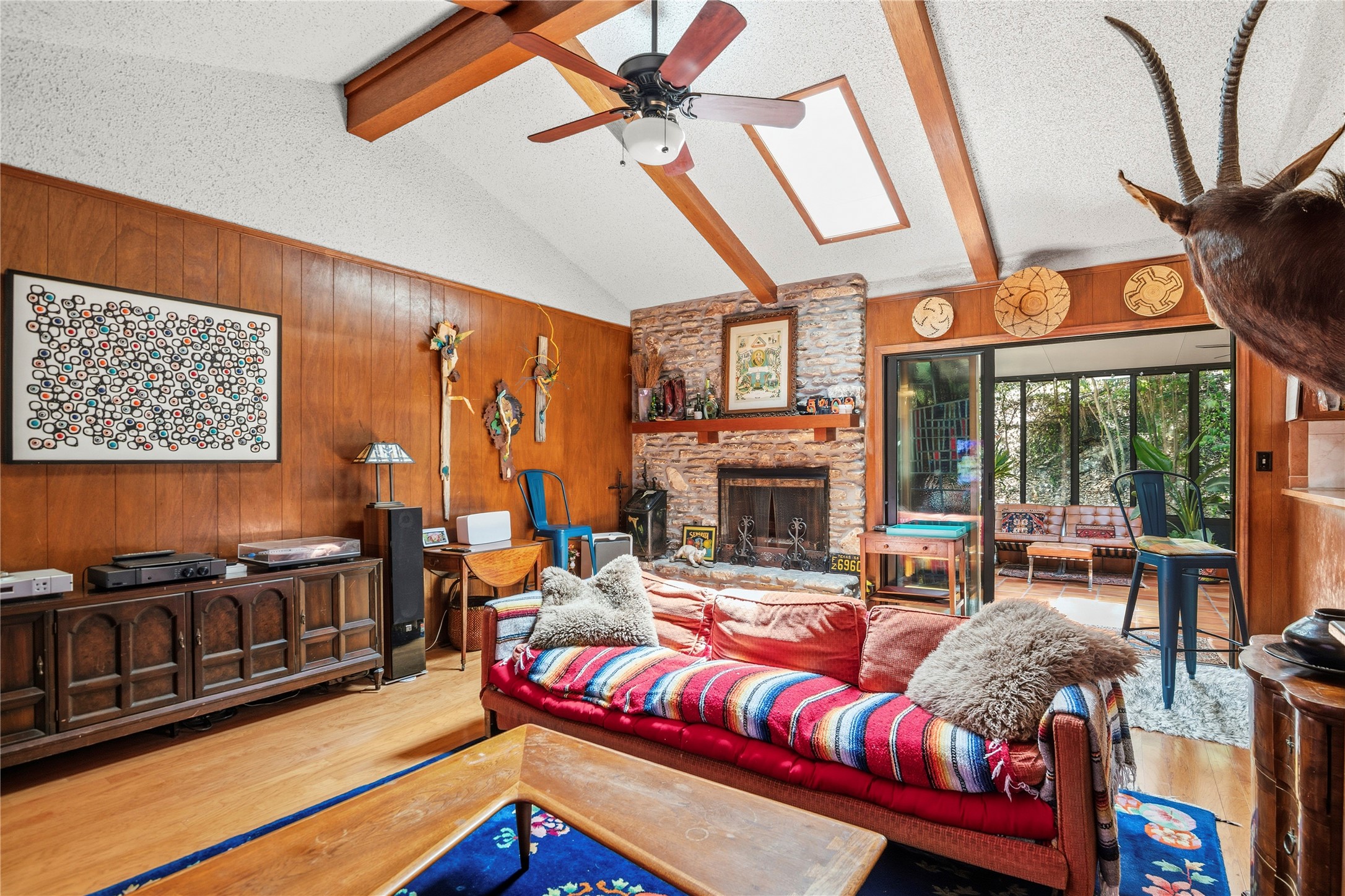 5403 Jeffburn Cove Austin, TX 78745 - Photo 10 of 40 a living room with furniture a flat screen tv and a floor to ceiling window